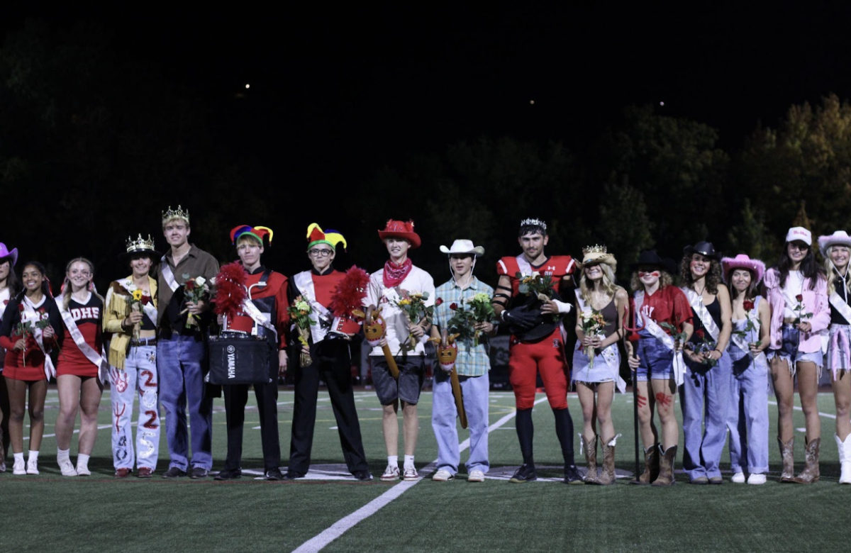 Homecoming royalty nominees stand for a photo after crowning the Homecoming King, Queen, Knights and Jesters during half time of the Homecoming football game at DHS on Sep. 27, 2024. Almost 40 nominees line up on the field, representing their clubs and sports. 
